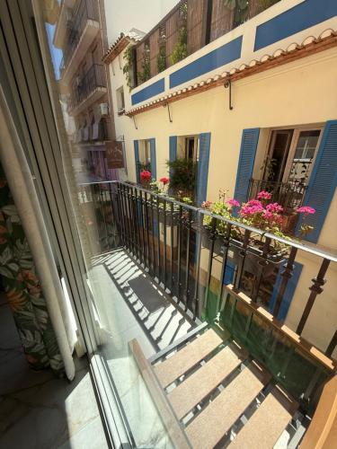 a balcony of a building with benches and flowers at Boomerang in Benidorm