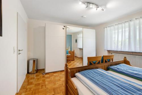 a bedroom with a bed and a living room at Ferienwohnung Lemke in Donaueschingen
