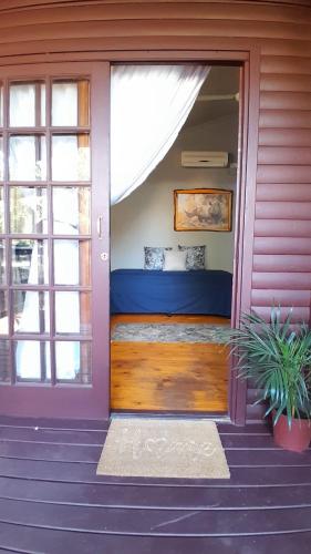 a front door of a house with a bed in it at Koshys Haven at Kruger in Malelane