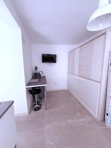 a white room with a desk and a computer in it at Boomerang in Benidorm