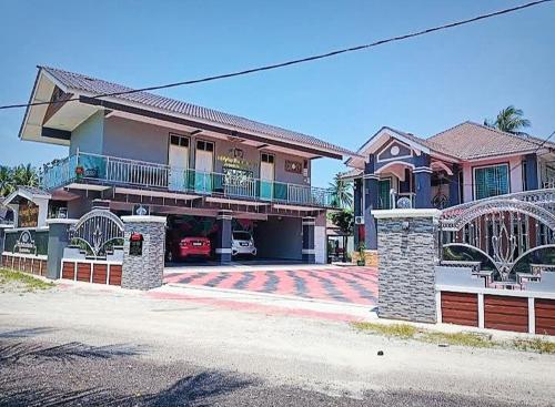 a large house with a car parked in front of it at Airport Riverside Roomstay & Homestay in Kota Bharu