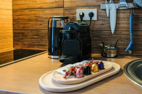 a plate of food on a counter with a coffee maker at Agneta Apartamentai in Druskininkai