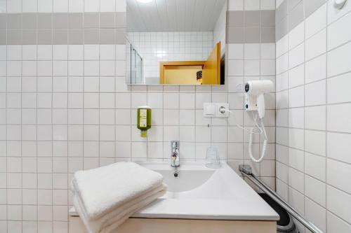 a white bathroom with a sink and a mirror at Bed and Breakfast St Wendel in Prüm