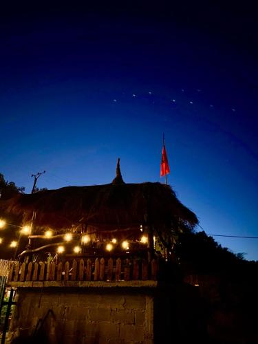 a flag on top of a building at night at Velaj Guest House in Cfir