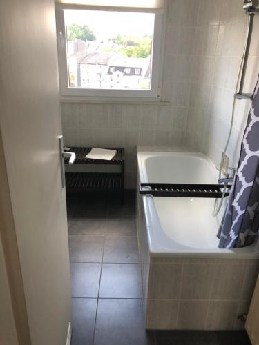 ein Badezimmer mit Badewanne und Fenster in der Unterkunft HagenStay Mittelstadt 1 in Hagen