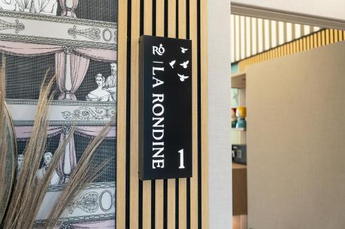 a sign on a door with a pile of money at Roby's Boutique Rooms - Luxury B&B in Catania
