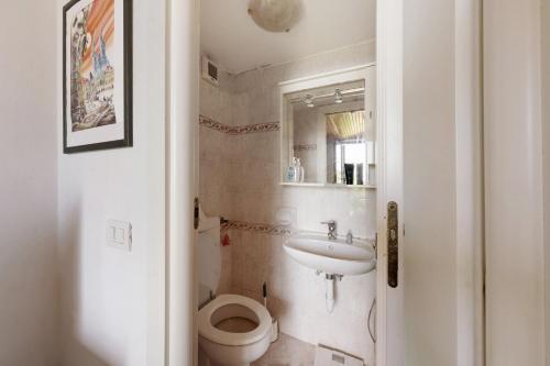 a bathroom with a toilet and a sink at Casa Paola in Moneglia