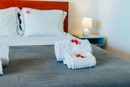 two towels on a bed in a hotel room at Rent4rest - Sesimbra Ocean View Studio in Sesimbra