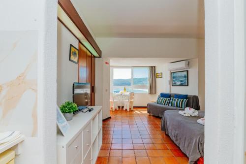 a living room with a bed and a couch at Rent4rest - Sesimbra Ocean View Studio in Sesimbra