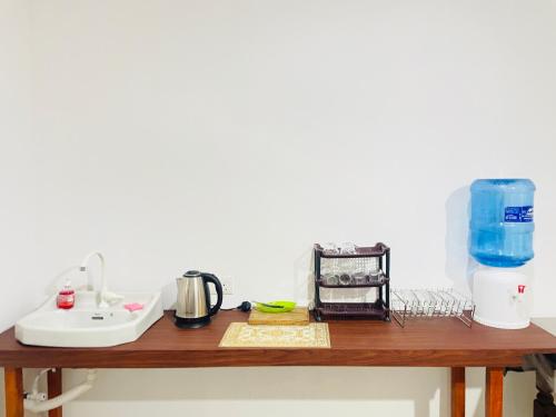 a wooden counter top with a sink and a mixer at Crystal Wave in Weligama
