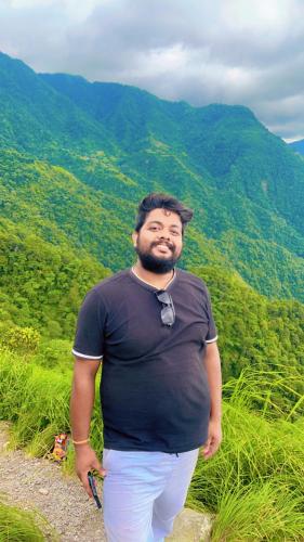 a man standing on a path in the mountains at TEC Resort and bar in Dharān Bāzār