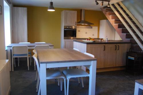 a kitchen with a table and chairs in a room at Gîte de la Fontaine in Beauraing