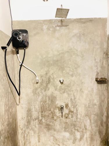 a camera on the wall of a dirty room at Crystal Wave in Weligama