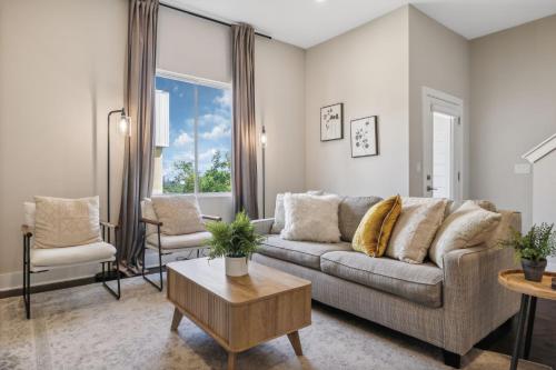 a living room with a couch and a table at Country Music Themed Goodrich Ave by SkyRun Nashville in Nashville