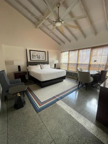 a bedroom with a bed and a table and chairs at Stonetrail in Arnos Vale