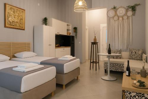 a room with three beds and a living room at Boho Sisi Resort - Poolside Oasis & Garden Vibes in Agios Nikolaos