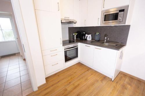 Kuchyň nebo kuchyňský kout v ubytování Ferienhaus Meer Zeit II