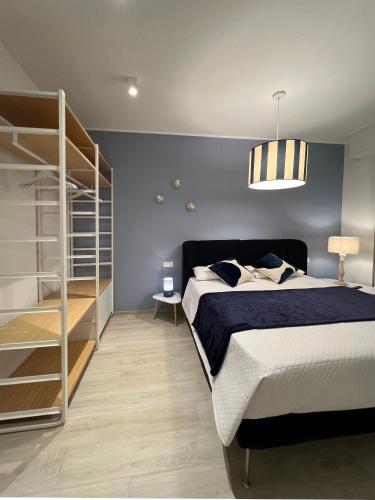 a bedroom with a bed and a book shelf and a bunk bed at Appartamento Gocce di sole in Pietra Ligure