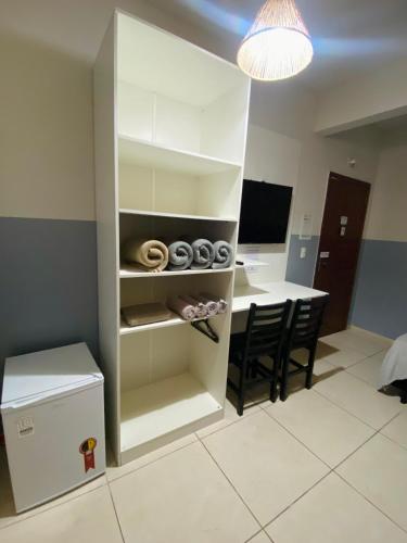 a kitchen and dining room with a table and chairs at Pousada Brunetti in Penha