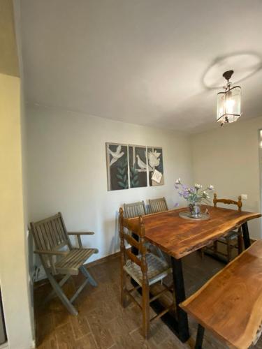 a dining room with a wooden table and chairs at Rizospito in Palaiokhóra