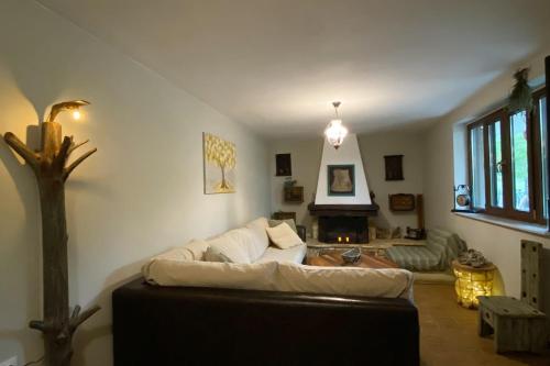 a living room with a couch and a fireplace at Rizospito in Palaiokhóra