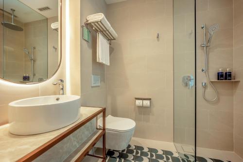 a bathroom with a sink and a shower at Dorsett Changi City Singapore in Singapore