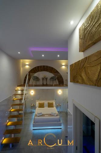 a bedroom with a bed and a spiral staircase at ARCUM suites in Palermo