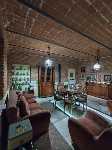 a living room with couches and a dining room at La Crota in Asti