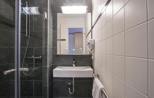 a bathroom with a sink and a mirror at Bastion Hotel Amsterdam Amstel in Amsterdam