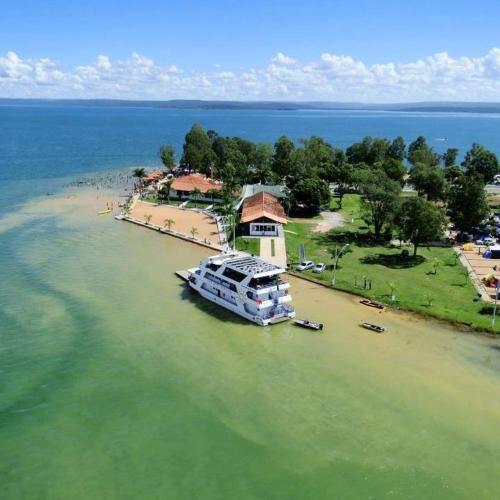 a boat parked in the water next to a house at Rooms A Sinos in Agiokampos
