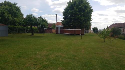 a large grassy yard with a basketball hoop at Chalet du Tilleul in Poncey-lès-Athée