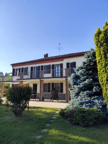 a large building with a balcony and a yard at La Crota B&B in Asti