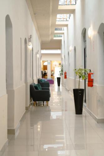 a hallway with couches and chairs in a building at Casona Plaza Hotel Colonial in Arequipa