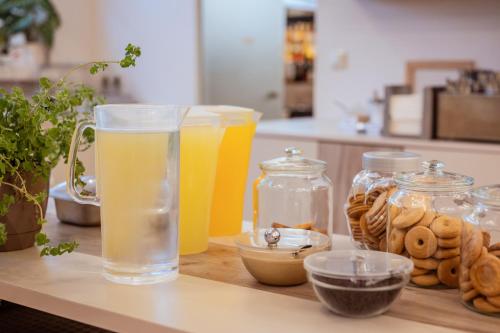 a table with two glasses of orange juice and cookies at Hotel Varres in Zakynthos Town