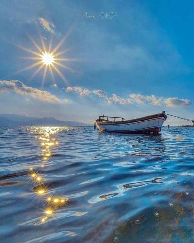 a boat sitting in the middle of the water at Rooms A Sinos in Agiokampos
