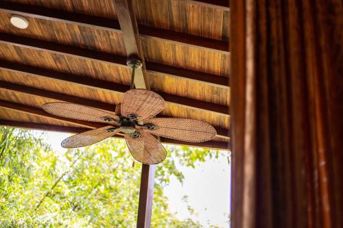 a brown ceiling fan hanging from a window at Portales del Tayrona Garden Hotel in Calabazo