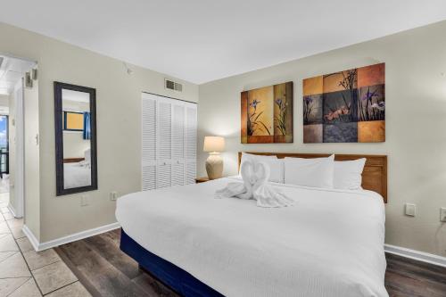 a bedroom with a large white bed in a room at Oceanfront Condo with Balcony in Myrtle Beach