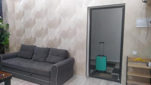 a living room with a couch and a mirror at Apartments in the center in Dushanbe