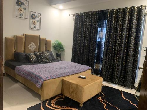 a bedroom with a king sized bed and black curtains at Subleasing Pakistan in Rawalpindi