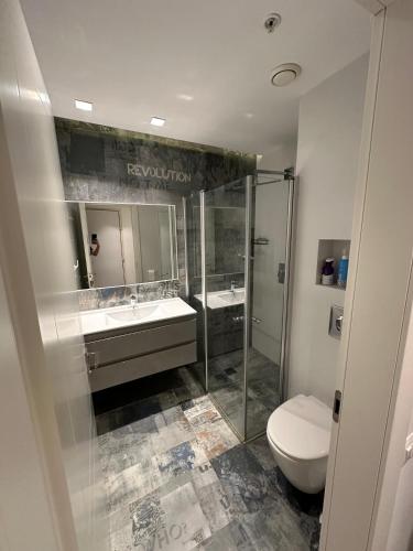 a bathroom with a toilet and a sink and a shower at Sea pearl tower in Netanya
