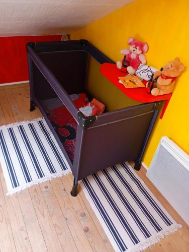 a bunk bed with stuffed animals on it in a room at Le Charmant Duplex in Cognac