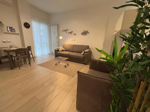 a living room with a couch and a table at Cozy studio 700m from the Milan red metro in Sesto San Giovanni