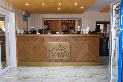 a bar in a restaurant with a sign that reads danish cuisine at Pensiunea Paradis Buzias in Buziaş