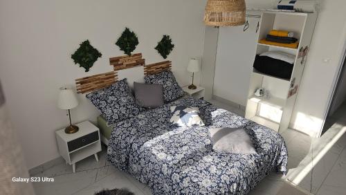 a bedroom with a bed with a dog on it at Le soleil de l'estaque in Marseille