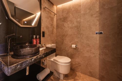 a bathroom with a toilet and a sink at The Unexpected Ibiza Hotel - Ushuaïa Club entrance included in Playa d'en Bossa