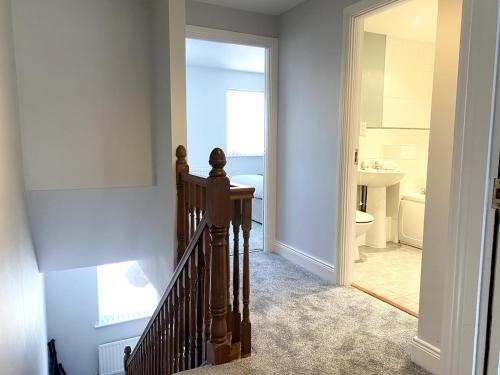 a hallway with a stairway leading to a bathroom at Cosy City Centre Townhouse in Elswick