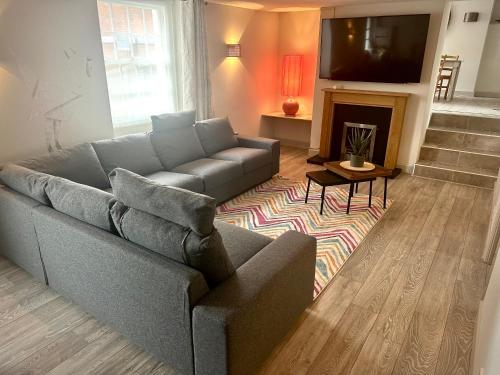 a living room with a couch and a fireplace at Stay at No12 in Lyme Regis