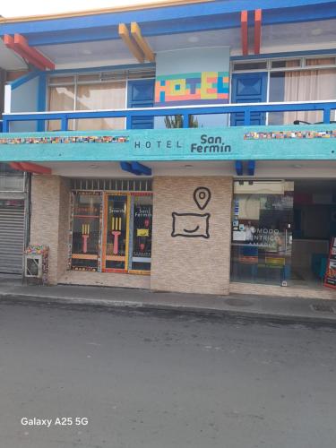 a hotel with a sign on the side of a building at Hotel San Fermin Pereira in Pereira