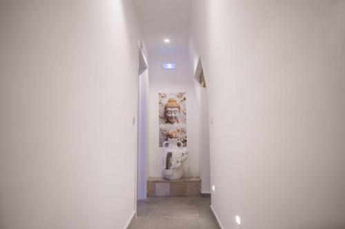 a hallway with a bathroom with a toilet in it at Tesse Suite in Canosa di Puglia