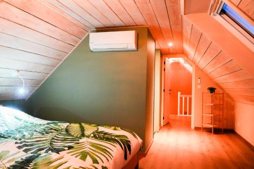a bedroom with a bed in a room with a staircase at B&B Heinehoeve in Kaprijke
